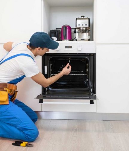 man repairing oven - About Brooklyn Appliance Repair Pros - Oven Repair Brooklyn