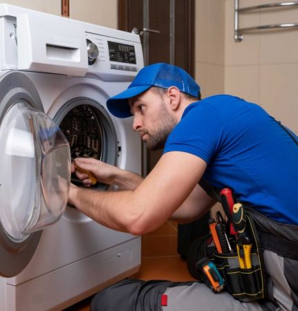 a technician repairing a washer and dryer repair brooklyn